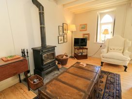 A living room with a stove and television at Cider Press Cottage Priston Village, Bath