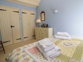 A bedroom with a bed and a dresser at Cider Press Cottage, Priston Village, Bath