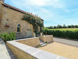 A stone exterior with front door and windows at Cider Press Cottage Priston Village, Bath