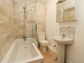 A bathroom with bathtub, shower, toilet and sink at Rojoy in Salisbury