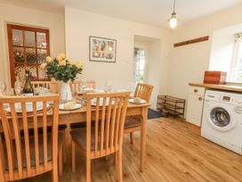 A dining room with a table set for a meal at Droop Farm Cottage Droop near Hazelbury Bryan