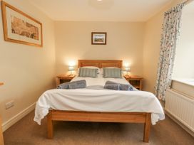 A bedroom with a bed and nightstands at Droop Farm Cottage Droop near Hazelbury Bryan