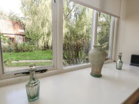 A window with decorative glass items at Droop Farm Cottage Droop near Hazelbury Bryan