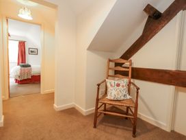 A hallway with a chair near a doorway at Droop Farm Cottage in Droop near Hazelbury Bryan