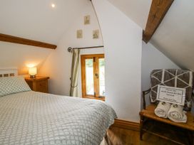 A bedroom with a bed and a window at The Shooting Folly in Cheswardine
