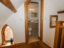 A staircase leading to a bathroom with a sink and toilet at The Shooting Folly in Cheswardine