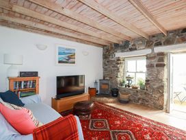 A living room with a sofa and television at Greeb Rocks Cottage in Marazion