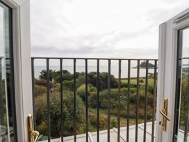A view from a balcony showing the sea and landscape at Greeb Rocks Cottage in Marazion