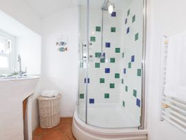 A bathroom with a shower and sink at Greeb Rocks Cottage in Marazion