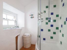 A bathroom with a shower and sink at Greeb Rocks Cottage, Marazion