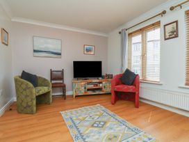 A living room with a tv and two chairs at Haven House in Whitby