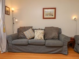 A living room with a sofa and cushions at Haven House in Whitby