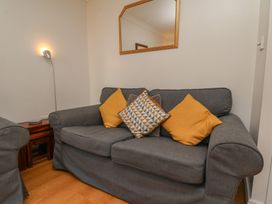 A living room with a sofa and floor lamp at Haven House in Whitby