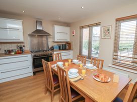 A kitchen with dining table and stove at Haven House in Whitby