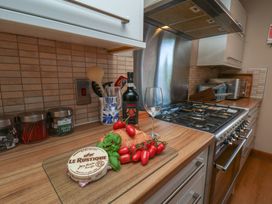 A kitchen with cooking utensils and food items at Haven House in Whitby