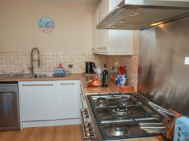 A kitchen with a sink and gas stove at Haven House in Whitby