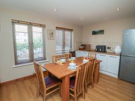 A kitchen with a dining table and chairs at Haven House in Whitby