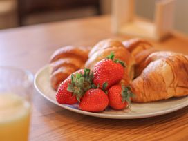 A plate of croissants and strawberries on a table at Haven House in Whitby