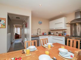 A kitchen with dining table and appliances at Haven House in Whitby