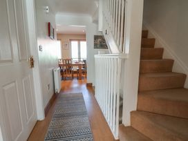 A hallway with stairs and a dining area visible at Haven House in Whitby