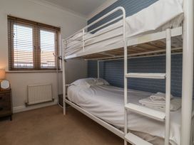 A bedroom with a bunk bed and a nightstand at Haven House in Whitby