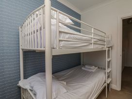 A bedroom with a bunk bed and sheets at Haven House in Whitby