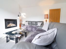 A living room with a sofa and coffee table at Arnant in Dolgellau