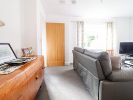 A living room with a sofa and television at Arnant in Dolgellau