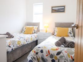 A bedroom with two beds and a lamp at Arnant in Dolgellau