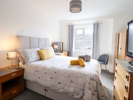 A bedroom with a bed and wooden furniture at Arnant in Dolgellau