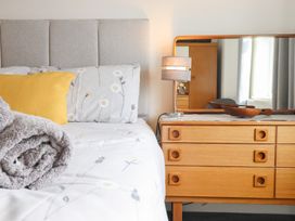 A bedroom with a bed and dresser at Arnant in Dolgellau