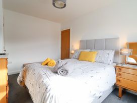A bedroom with a bed and bedside table at Arnant in Dolgellau