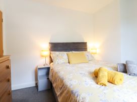 A bedroom with a bed and bedside table at Arnant in Dolgellau