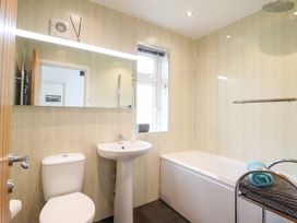 A bathroom with a bathtub and sink at Arnant in Dolgellau