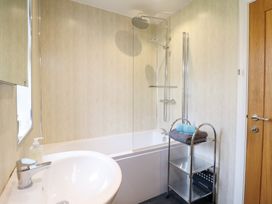 A bathroom with a bath tub and shower at Arnant in Dolgellau