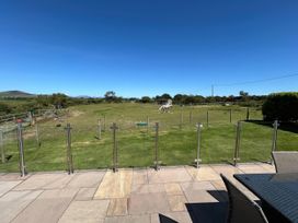A garden with a horse and patio furniture at Rhos Y Foel Cottage Nefyn
