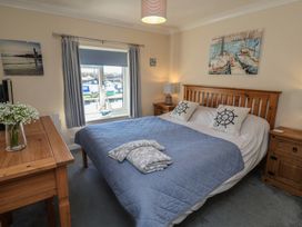 A bedroom with a bed and a desk at Daisy Lodge in Norwich