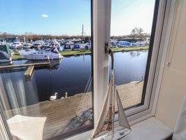 A view from a window showing boats and water at Daisy Lodge in Norwich