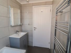 A bathroom with a sink and mirror at Daisy Lodge in Norwich