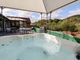 An outdoor area with a hot tub and seating at Talgais in Llangollen