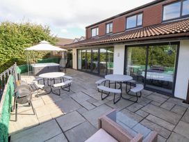 An outdoor patio with seating and a hot tub at Talgais in Llangollen