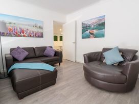 A living room with a sofa and a chair at Talgais in Llangollen