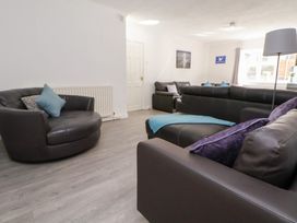 A living room with sofas and an armchair at Talgais in Llangollen