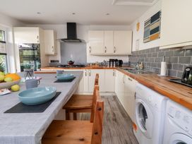A kitchen with a table and chairs at Talgais in Llangollen