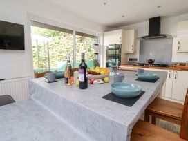 A kitchen with a table set for dining at Talgais in Llangollen