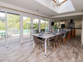 A dining room with a large table and chairs at Talgais in Llangollen