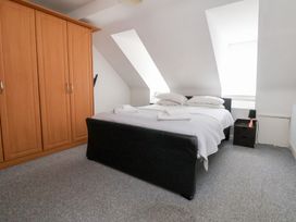 A bedroom with a bed and wardrobe at Talgais in Llangollen