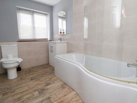 A bathroom with a bathtub and toilet at Talgais in Llangollen