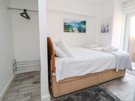 A bedroom with a bed and wardrobe at Talgais in Llangollen