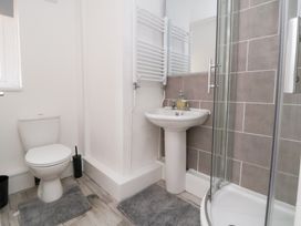 A bathroom with a shower, toilet, and sink at Talgais Llangollen